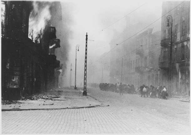 Des Juifs capturés durant l'insurrection sont emmenés vers la "Umschlagplatz" dans un ghetto en flammes. 